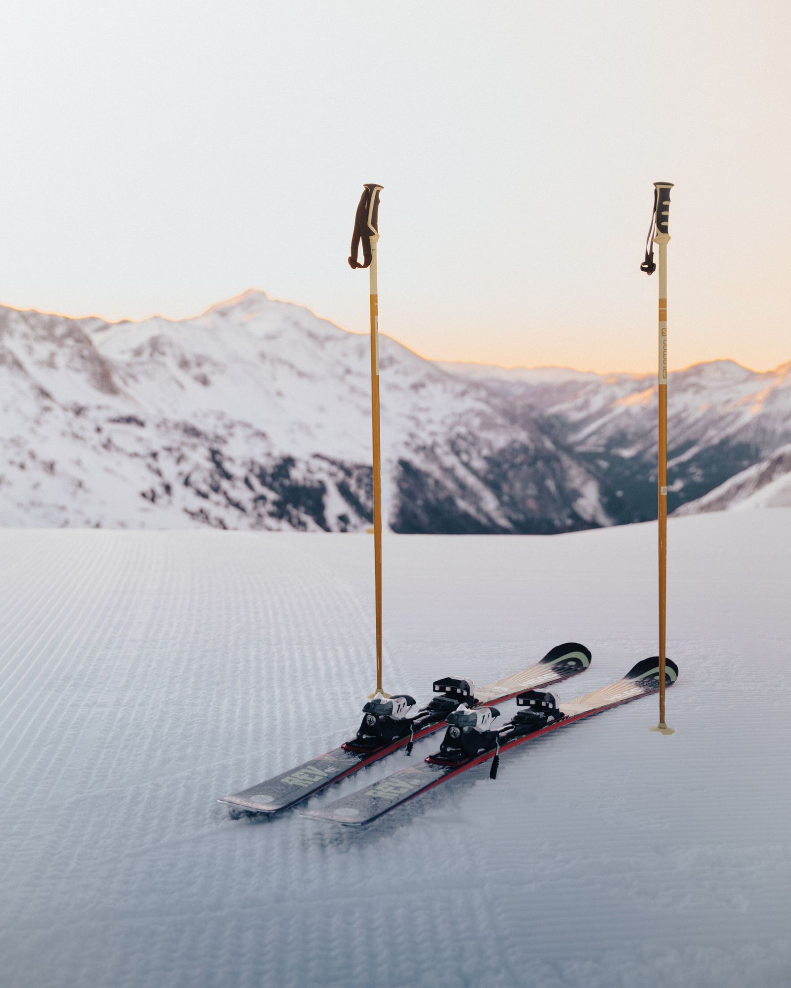 Skis and poles in the snow in front of the Obertauern mountains