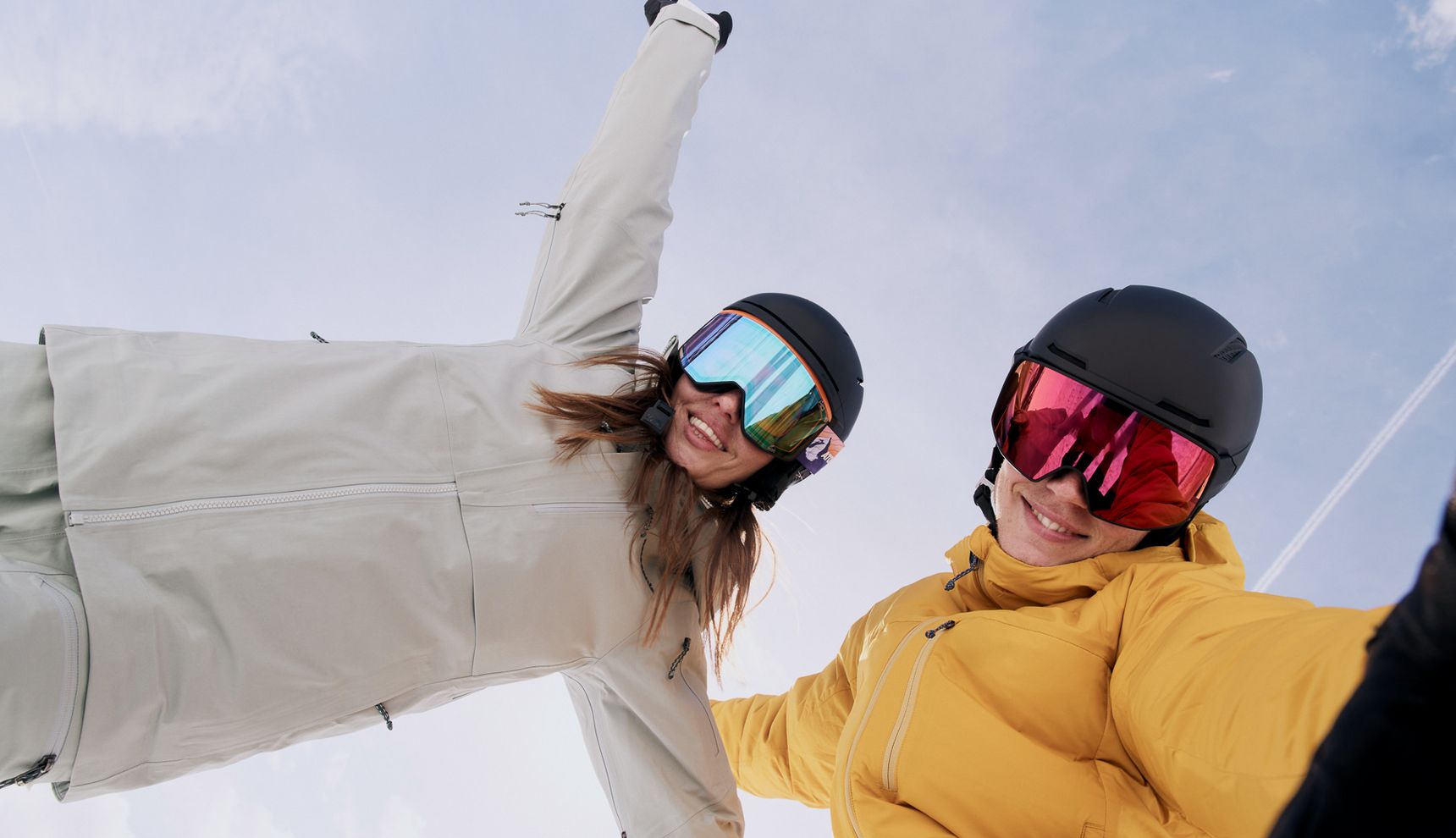 Two skiers with helmets and goggles in the snow